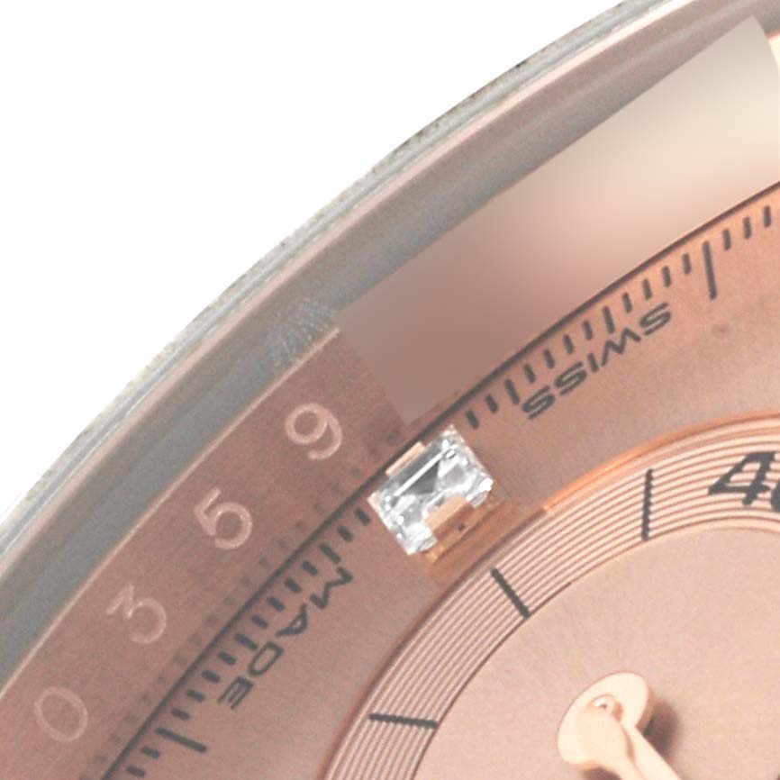 The image shows a close-up of the Rolex Daytona 116505 Men's Rose Gold Pink Dial 116505 Men's Rose Gold Pink Dial watch's dial with hour markers, minute markers, and part of the bezel.