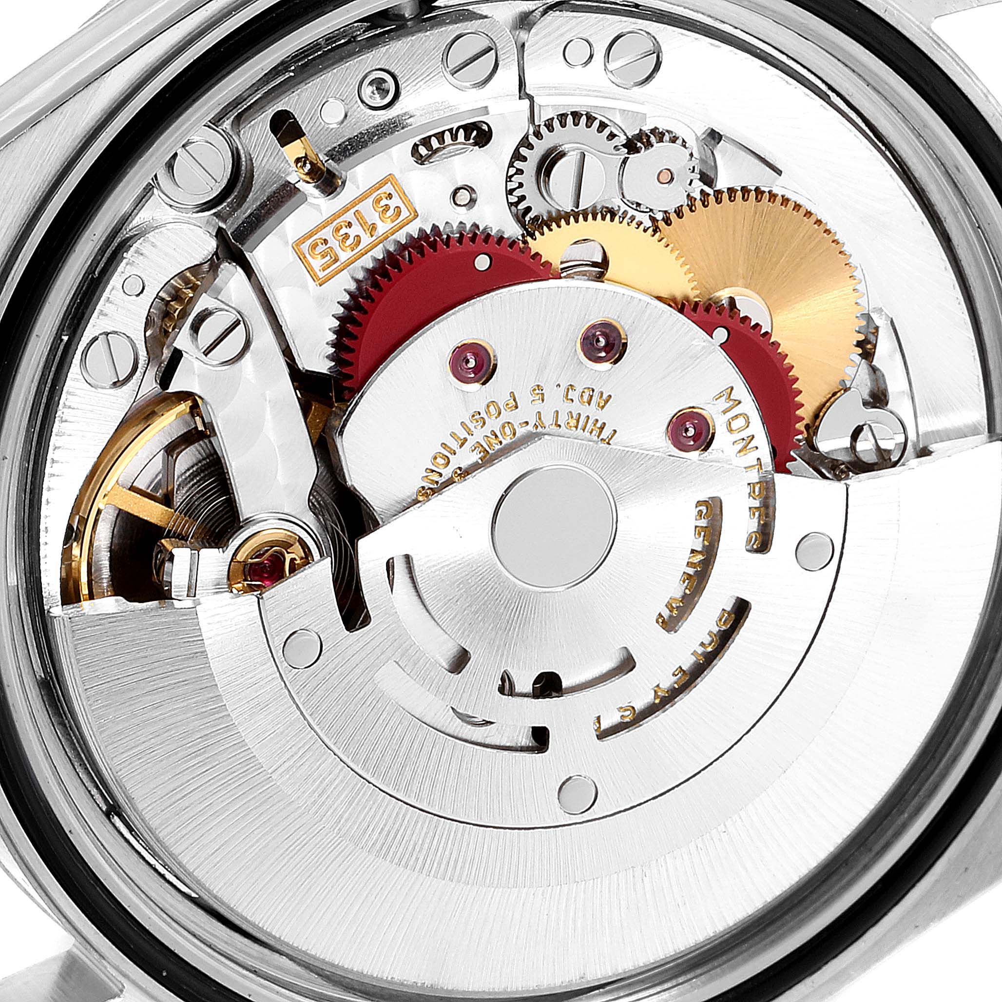 The image shows the intricate internal mechanism of a Rolex Datejust 16234 Men's Stainless Steel Blue Dial 16234 Men's Stainless Steel Blue Dial watch, focusing on the gears and rotor.