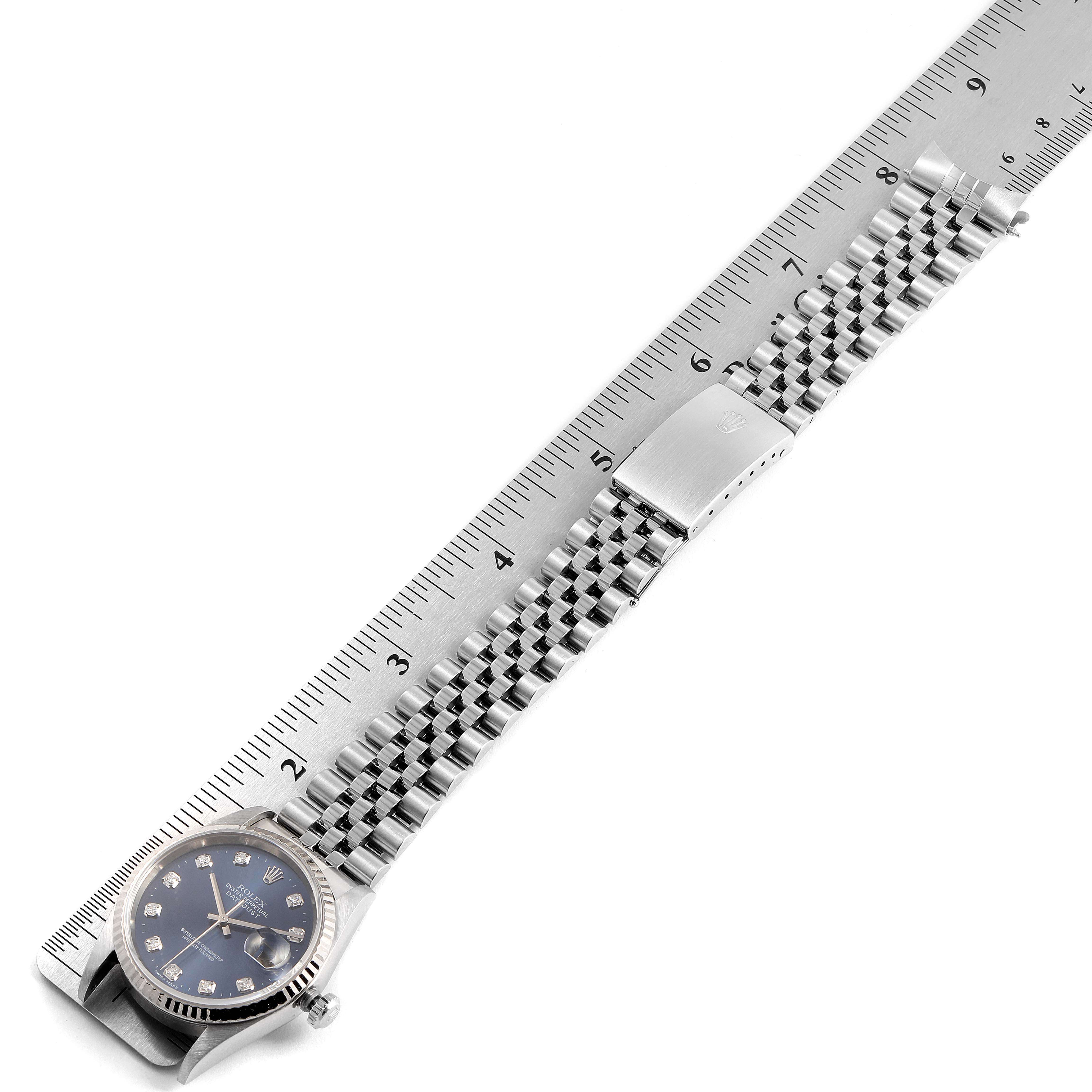 The image shows a Rolex Datejust 16234 Men's Stainless Steel Blue Dial 16234 Men's Stainless Steel Blue Dial watch laid flat with its full strap, placed next to a ruler.