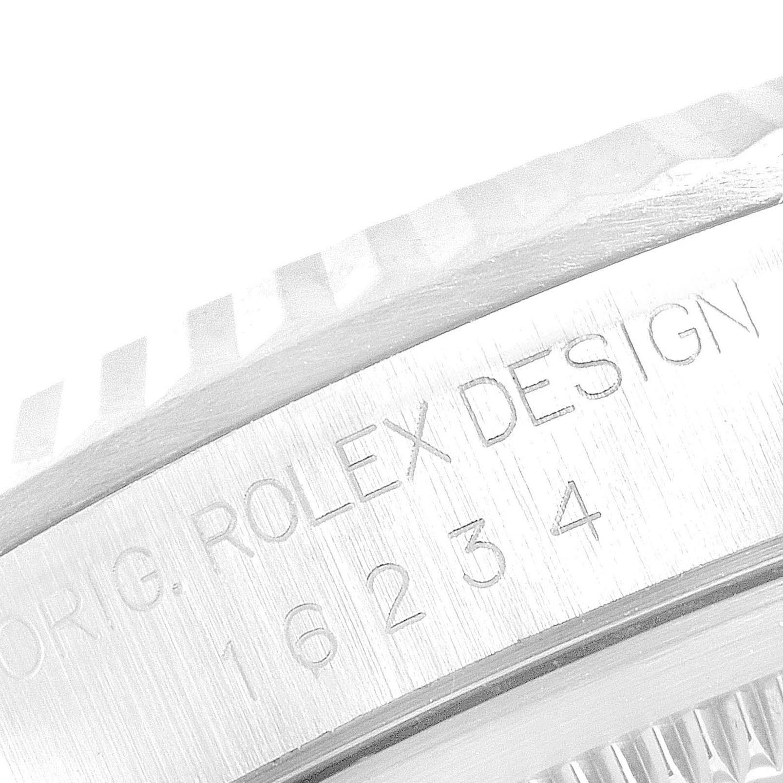 This close-up image shows the engraved bezel and serial number of a Rolex Datejust 16234 Men's Stainless Steel Blue Dial 16234 Men's Stainless Steel Blue Dial watch.