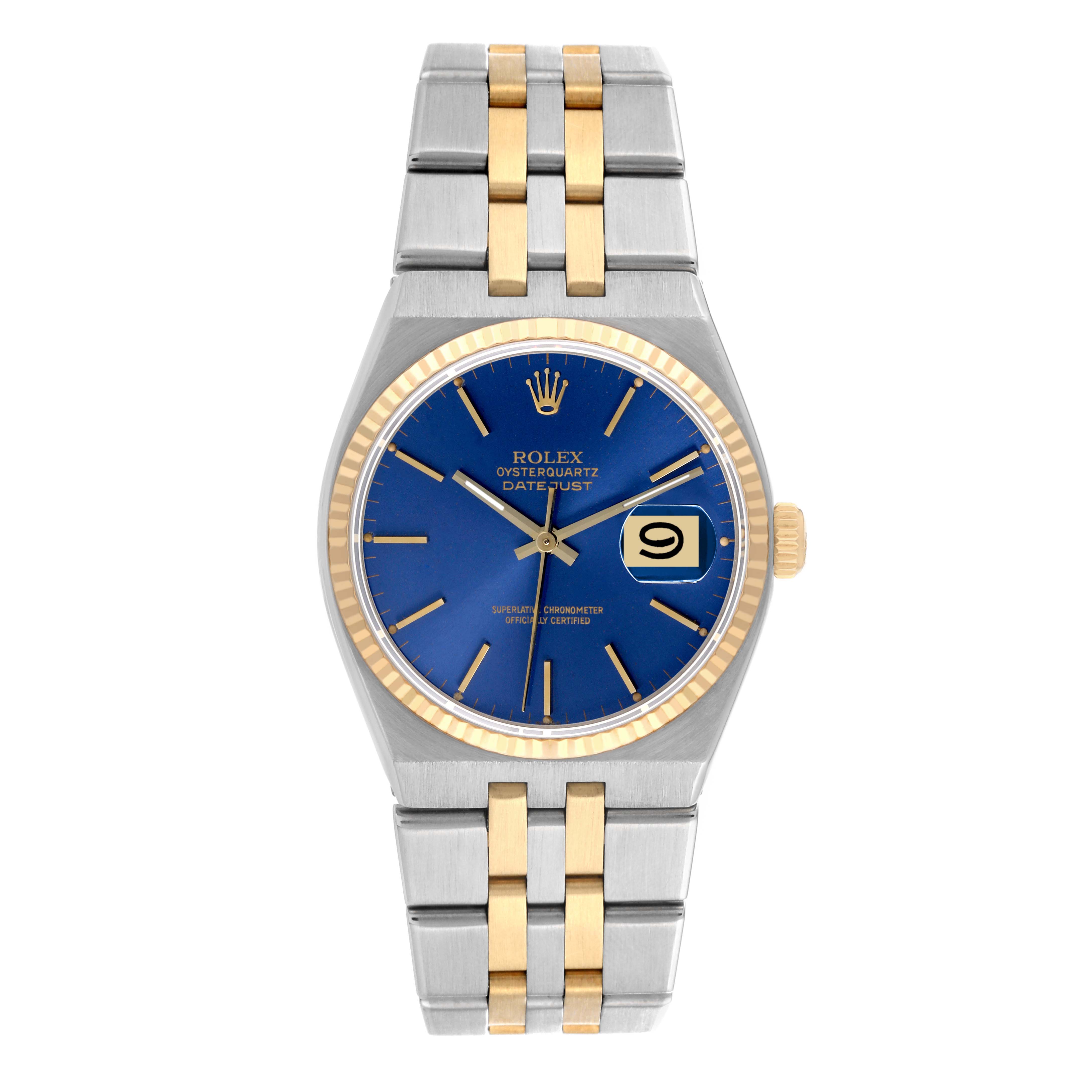 The image shows a Rolex Oysterquartz 17013 Men's Steel and Gold (two tone) Blue Dial 17013 Men's Steel and Gold (two tone) Blue Dial Datejust watch from a front angle, featuring a blue dial, gold bezel, and a two-tone bracelet.