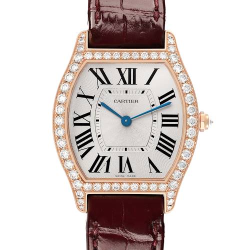 The Cartier Tortue WA501008 Women's Rose Gold Silver Dial watch is shown from a top-down angle, displaying its diamond-encrusted bezel, Roman numeral dial, and leather strap.