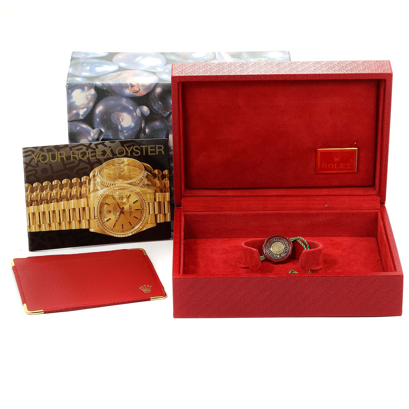 The image shows a Rolex President 69158 Women's Yellow Gold Champagne Dial 69158 Women's Yellow Gold Champagne Dial model watch with its box, booklet, and accessories from a front angle.