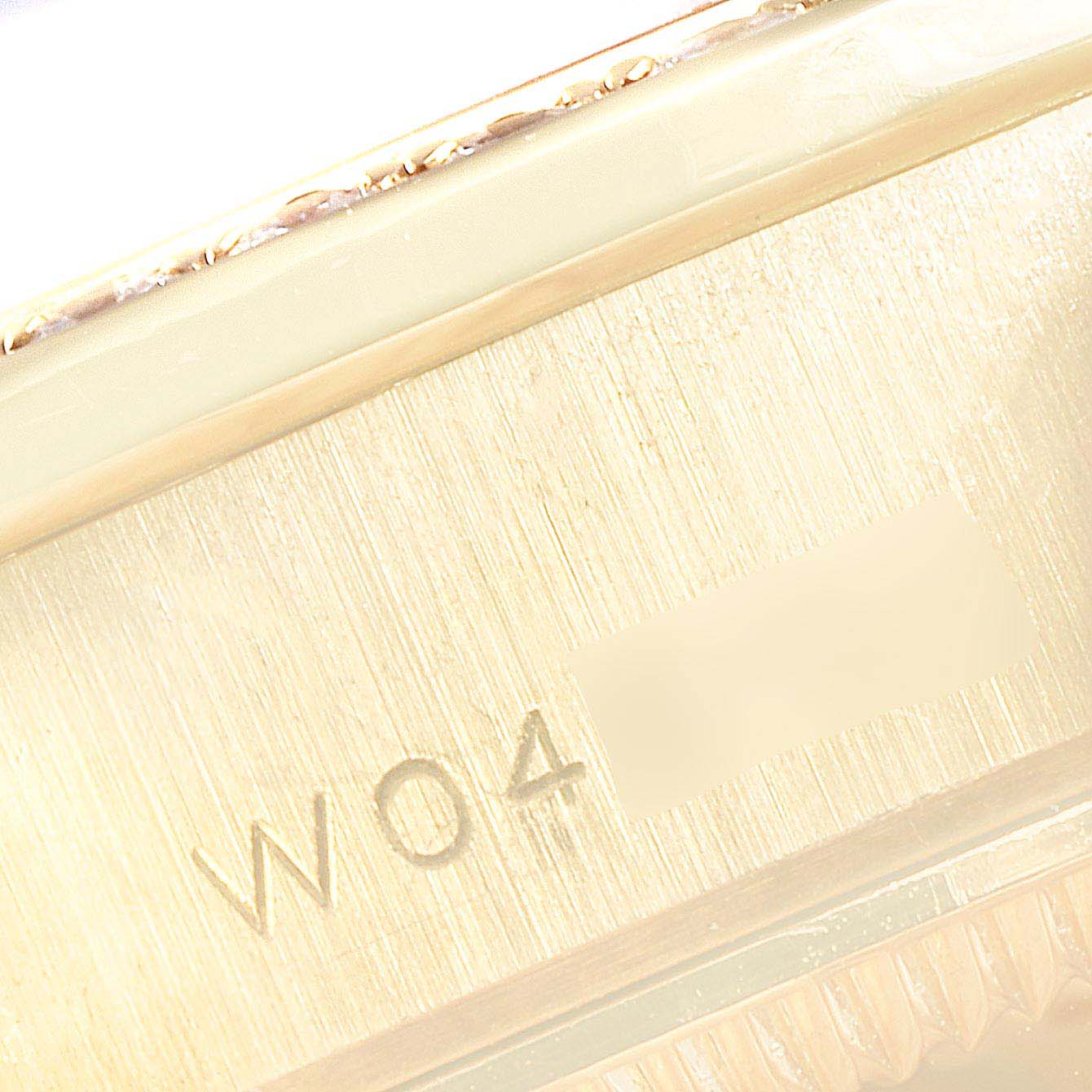 The image shows a close-up of the serial number engraved on the side of a Rolex President 69158 Women's Yellow Gold Champagne Dial 69158 Women's Yellow Gold Champagne Dial model watch.