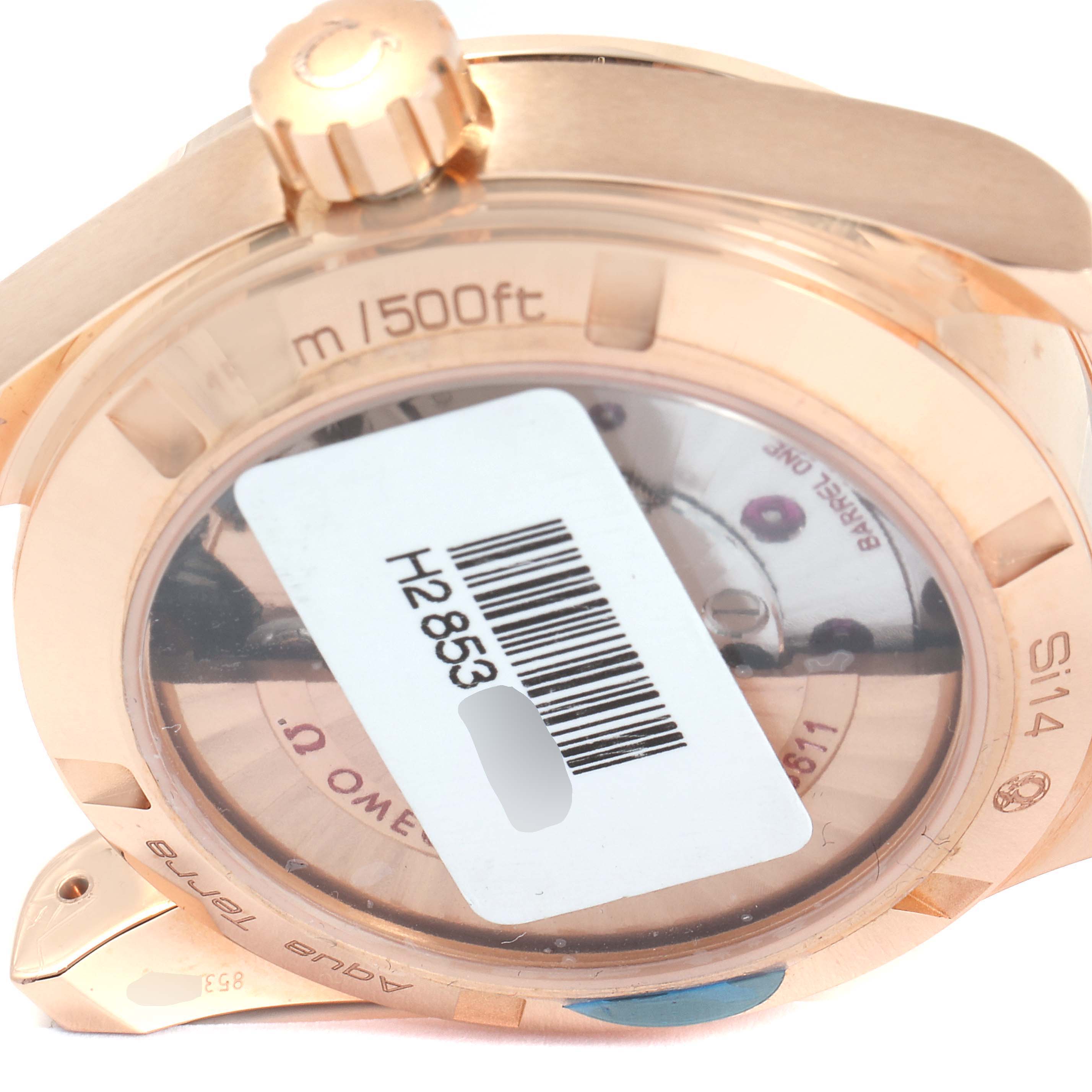 The image shows the backside of an Omega Aqua Terra 231.53.39.22.02.001 Men's Rose Gold Silver Dial 231.53.39.22.02.001 Men's Rose Gold Silver Dial watch, highlighting its case back and crown with a barcode sticker.