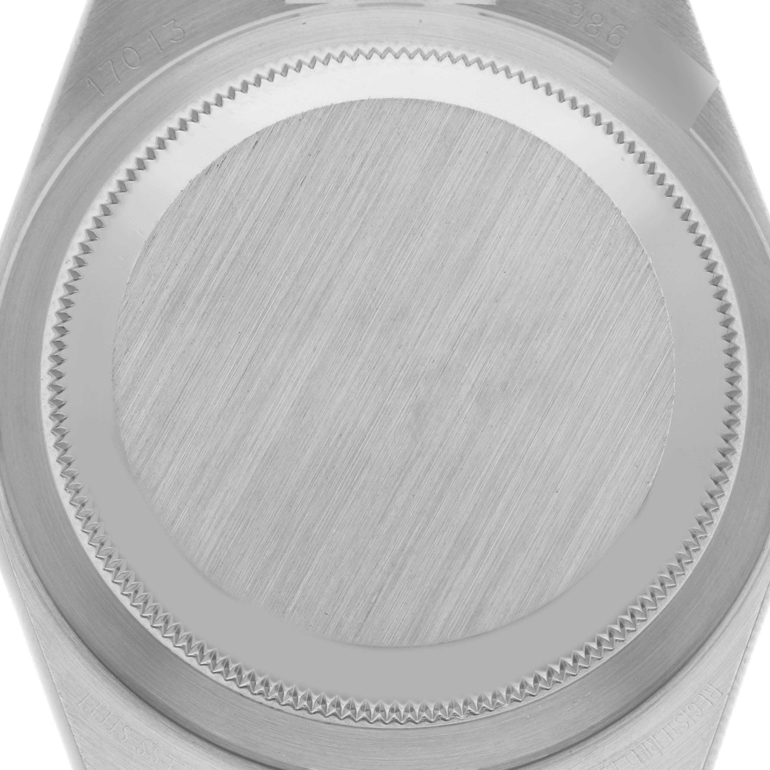 This image shows the back case of the Rolex Oysterquartz 17013 Men's Steel and Gold (two tone) Black Dial 17013 Men's Steel and Gold (two tone) Black Dial watch, viewed from a close-up angle, showcasing its brushed metal finish and serrated edges.