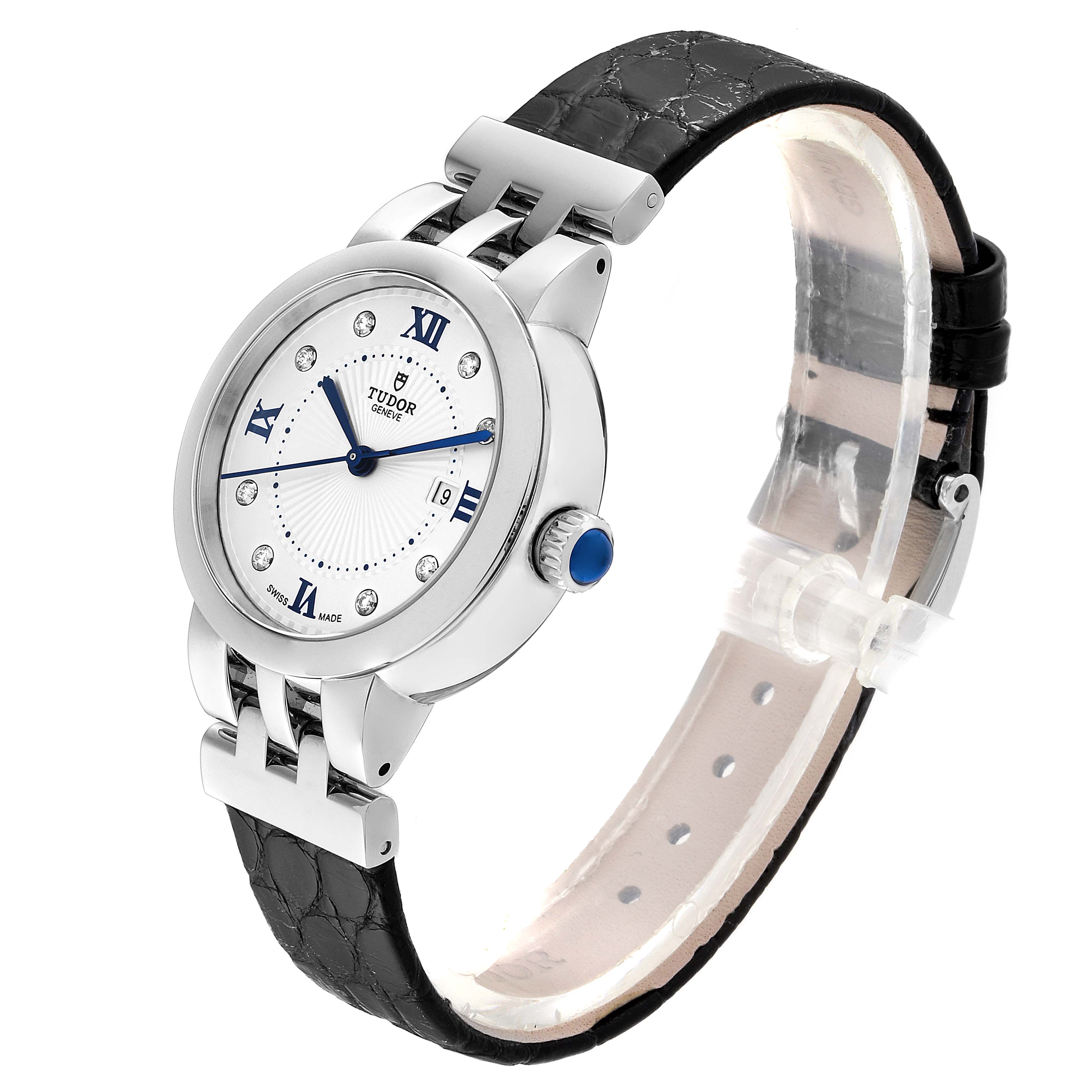 The image shows a Tudor Clair de Rose M35800-0006 Women's Stainless Steel Silver Dial M35800-0006 Women's Stainless Steel Silver Dial watch from an angled side view, highlighting its face, crown, and black leather strap.