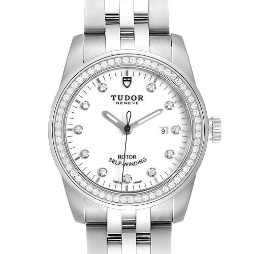 The image shows a front view of the Tudor Glamour M53020-0074 Women's Stainless Steel White Dial M53020-0074 Women's Stainless Steel White Dial watch, showcasing its bezel, dial, hands, and part of the bracelet.