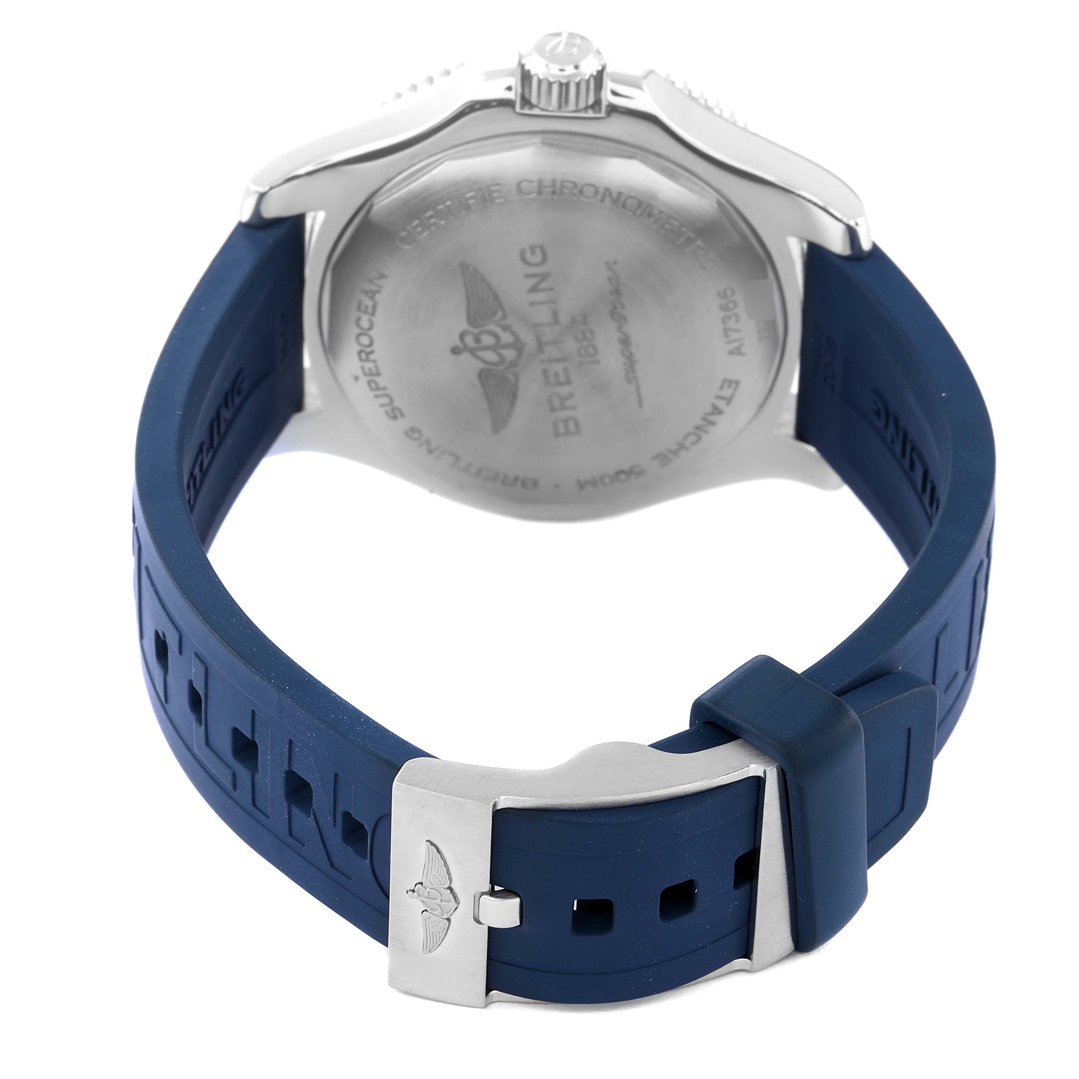 The image shows the back view of a Breitling Superocean A17366 Men's Stainless Steel White Dial A17366 Men's Stainless Steel White Dial watch, focusing on its case back, crown, and blue rubber strap with a clasp.