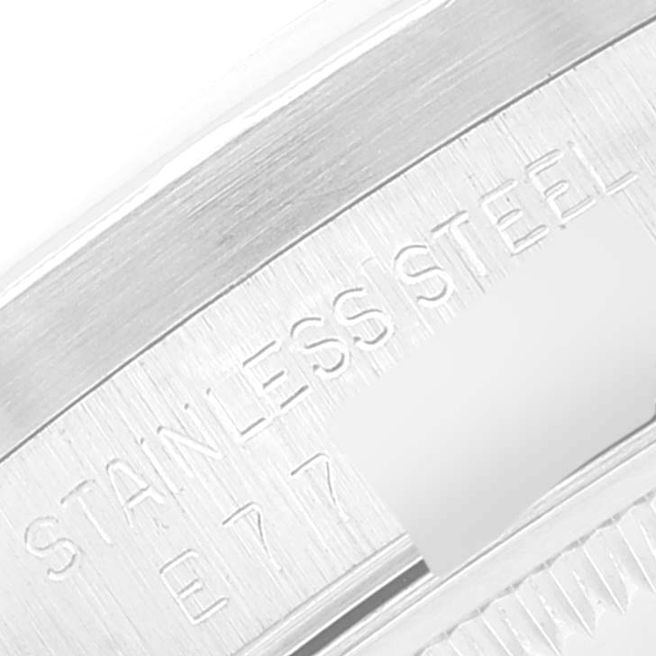 The image shows a close-up of the stainless steel case back of a Rolex Date 15210 Men's Stainless Steel Silver Dial 15210 Men's Stainless Steel Silver Dial model watch with etched serial numbers partially visible.