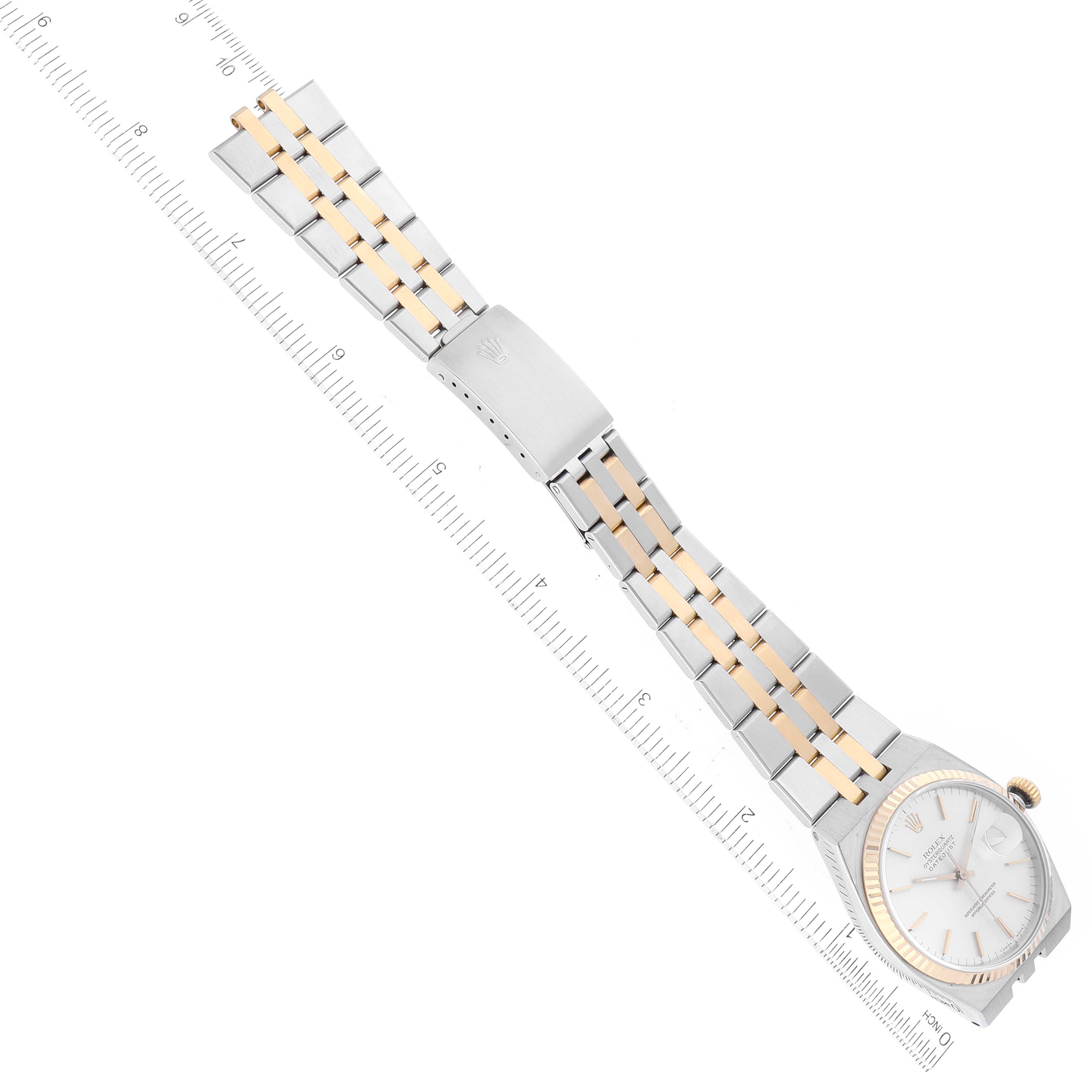 The image shows a Rolex Oysterquartz 17013 Men's Stainless Steel Silver Dial 17013 Men's Stainless Steel Silver Dial watch at a diagonal angle, highlighting the watch face, gold bezel, and two-tone metal bracelet.