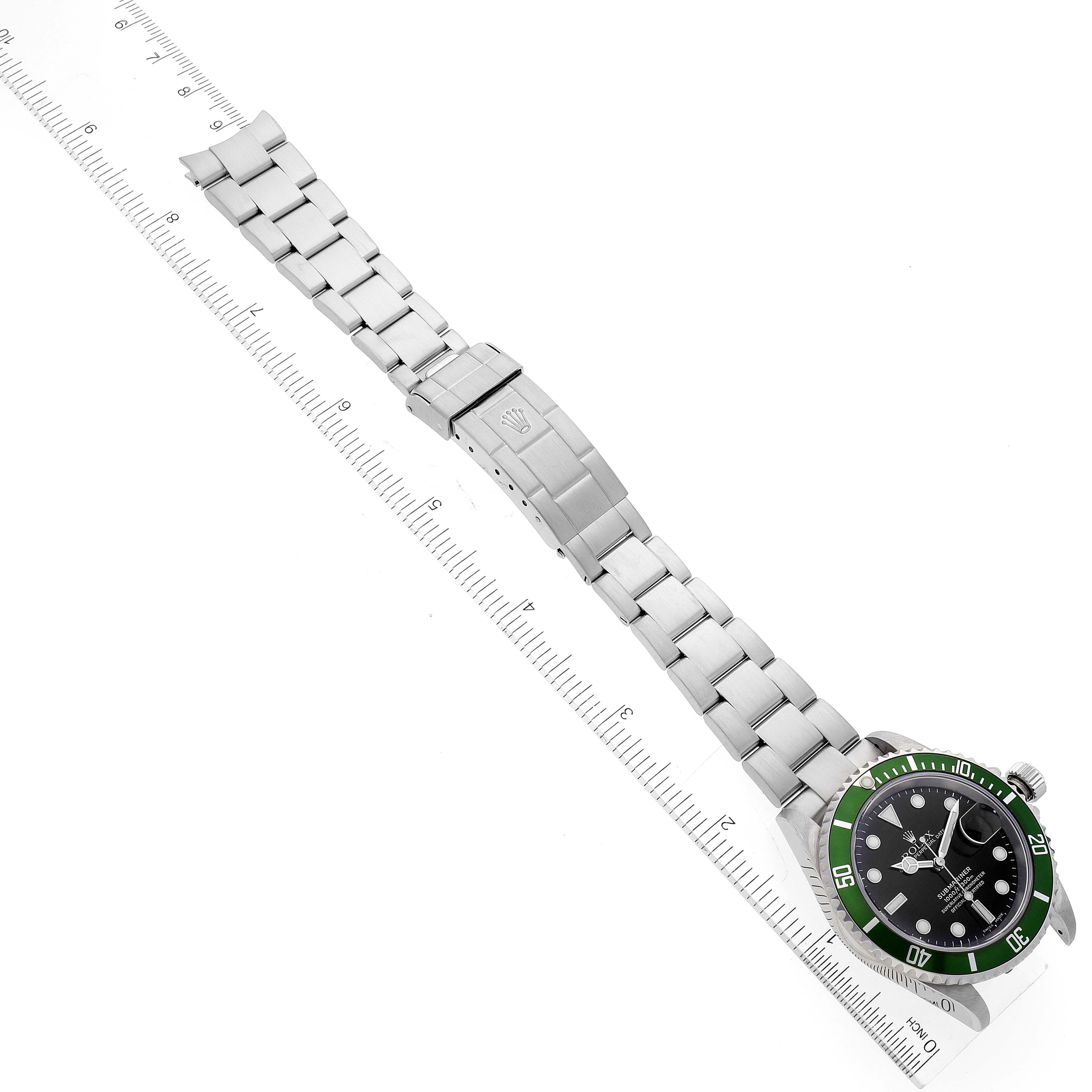 The image shows a top-down view of a Rolex Submariner 16610LV Men's Stainless Steel Black Dial 16610LV Men's Stainless Steel Black Dial watch with its full bracelet extended and placed alongside a ruler for scale.