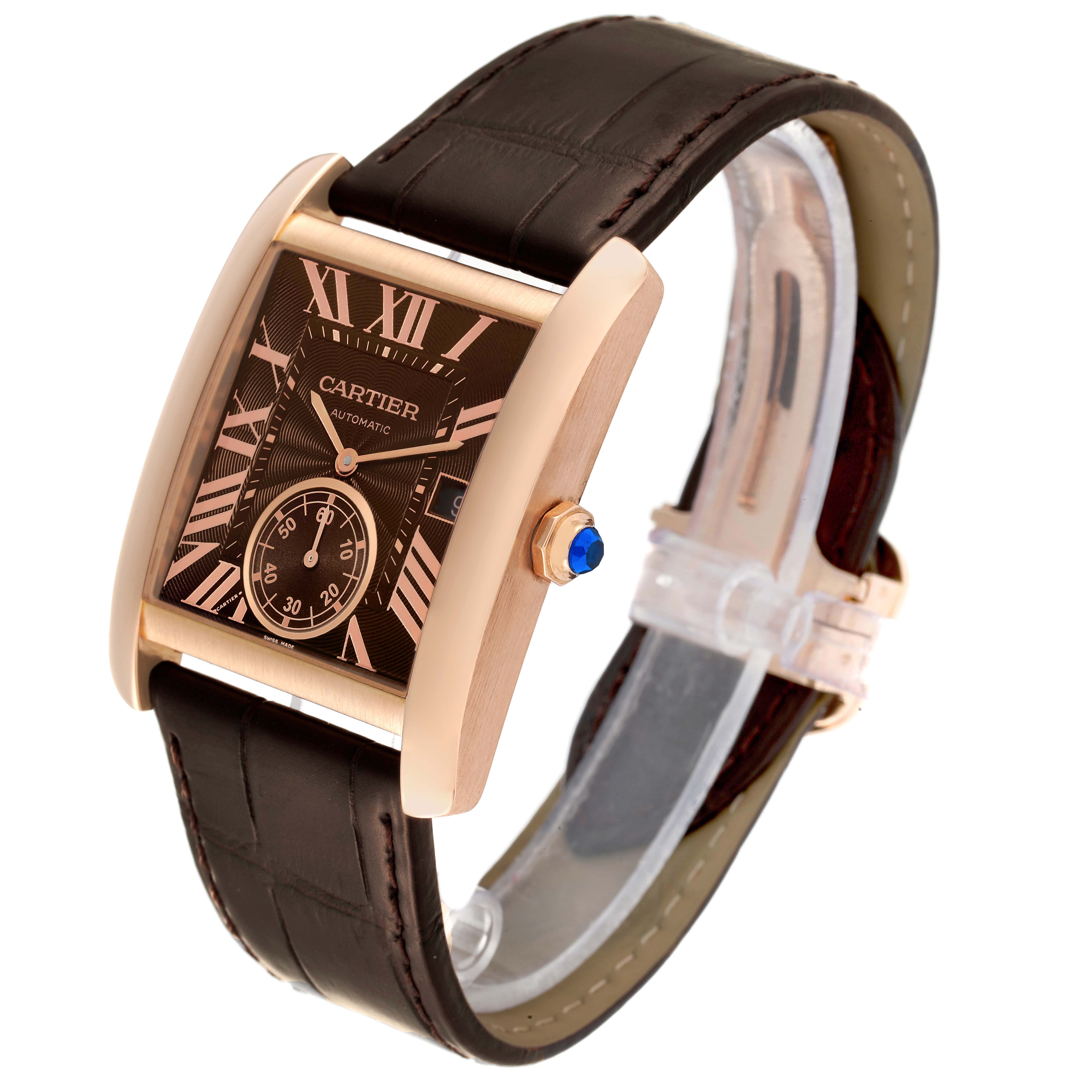 This Cartier Tank MC W5330002 Men's Rose Gold Brown Dial W5330002 Men's Rose Gold Brown Dial watch is shown at a tilted angle, highlighting its rectangular dial, brown leather strap, rose gold casing, and blue crown.