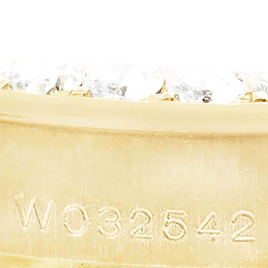 This close-up image of the Rolex Pearlmaster 69298 Women's Yellow Gold Mother of Pearl Dial 69298 Women's Yellow Gold Mother of Pearl Dial watch showcases the serial number engraving and a portion of the diamond-set bezel.